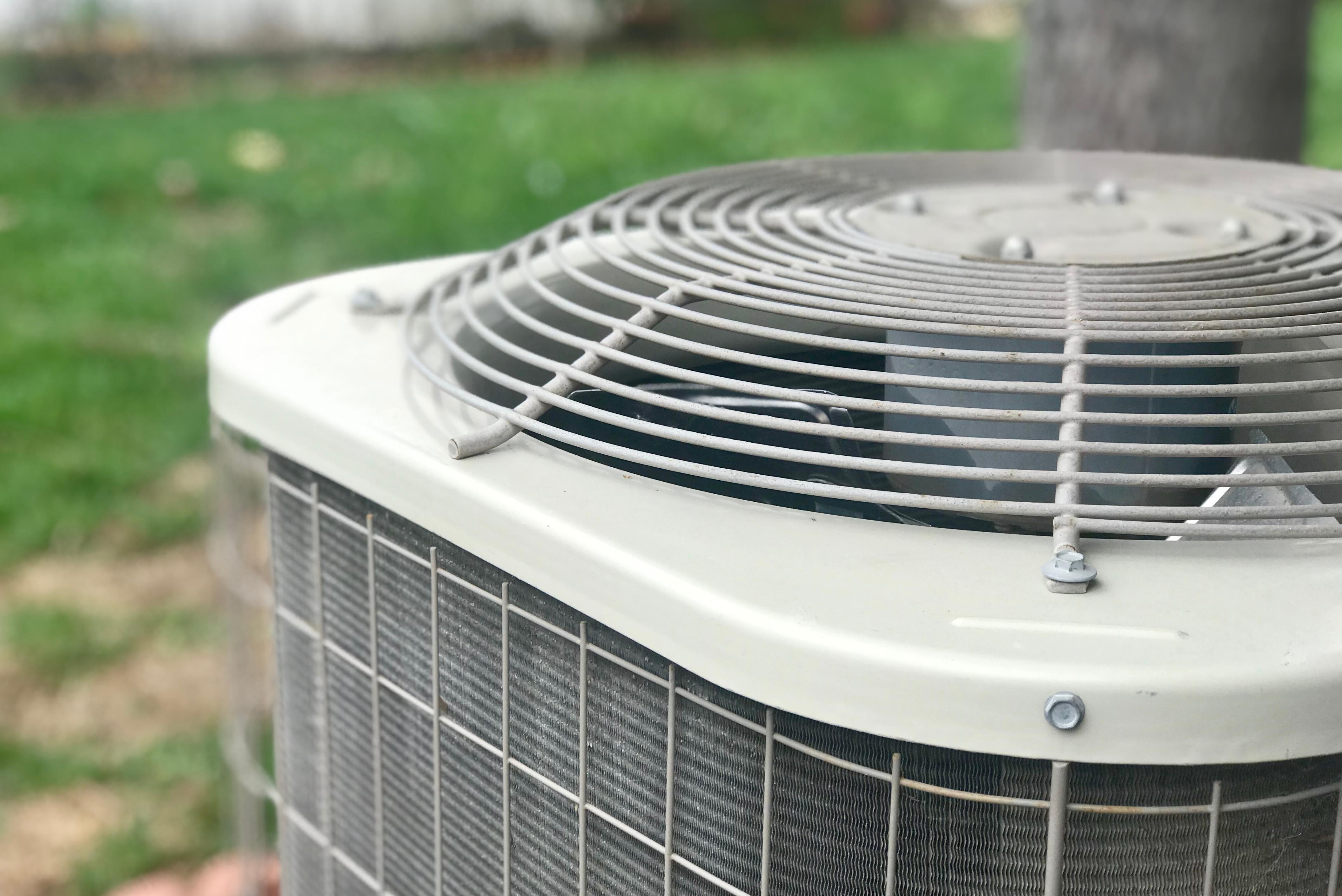Professional new AC condenser unit installed in residential outdoor space